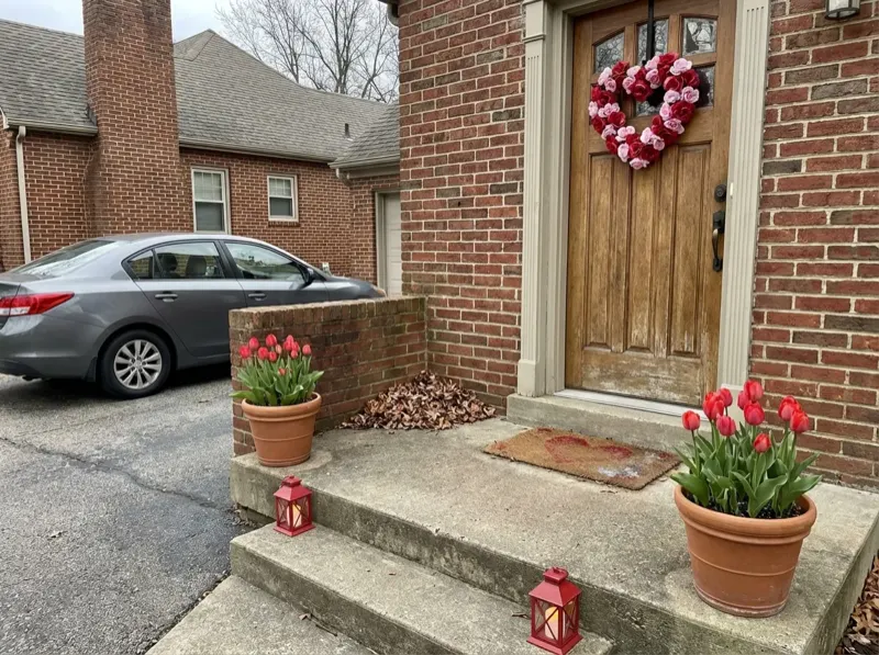 Beautiful Valentine's Day porch decorated with flowers and seasonal decor